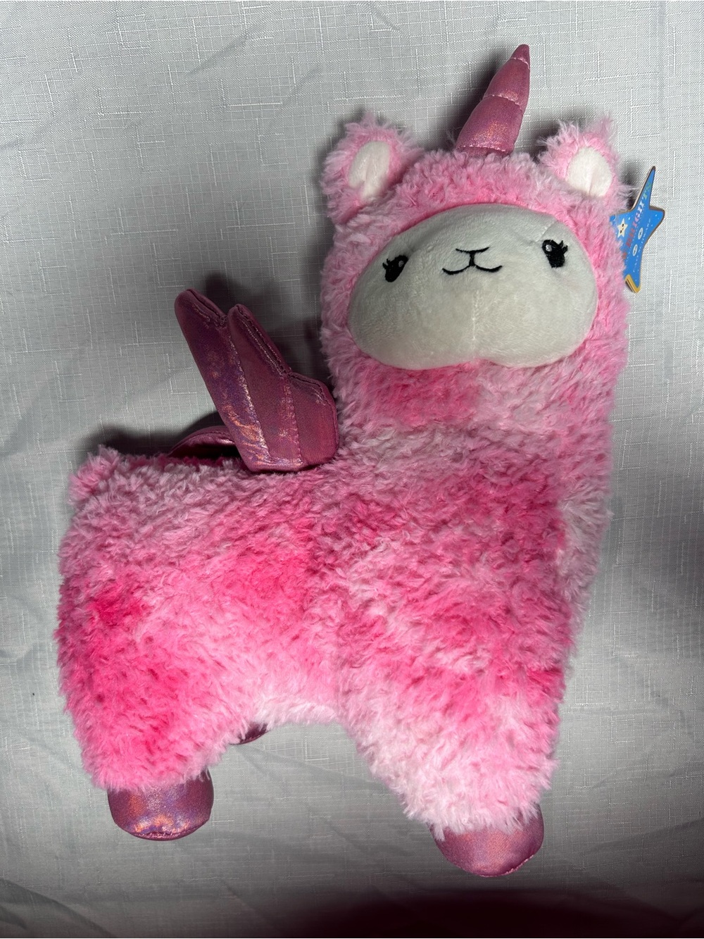 pink FAO Schwarz Glow Brights Llamacorn (a llama and unicorn hybrid plush toy)